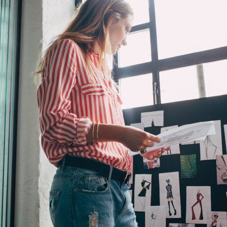 A Hearst female employee looks at editorial fashion sketches.