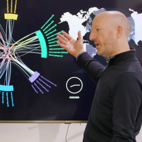 Image showing a Kin + Carta employee gesturing at a graph.