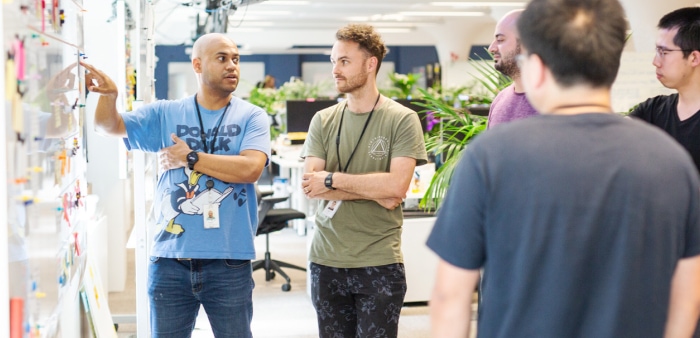 Group of people brainstorming a project using a whiteboard