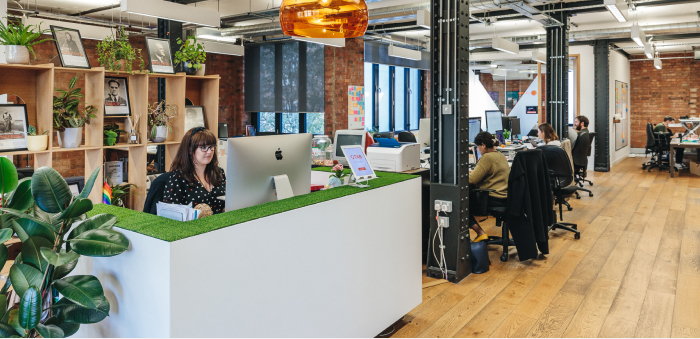 Image shows Kin + Carta’s offices with several employees working at computers.