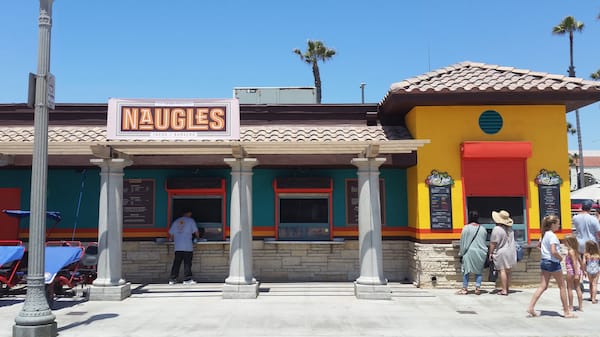 A modern building with bright walls labeled Naugles