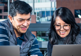 Two people looking at a laptop