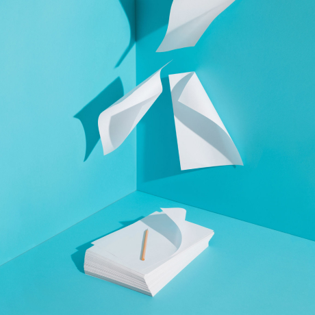 Sheets of white paper flying away
