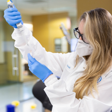 Scientist using a test tube.