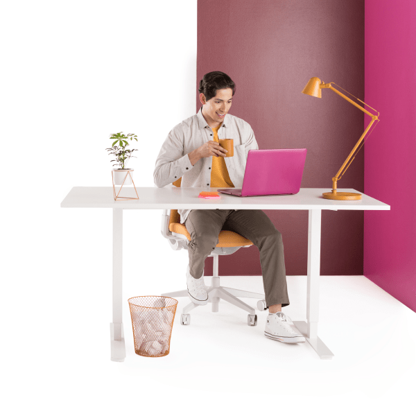Man sitting at desk with his laptop, collaborating with his HR team in Slack.