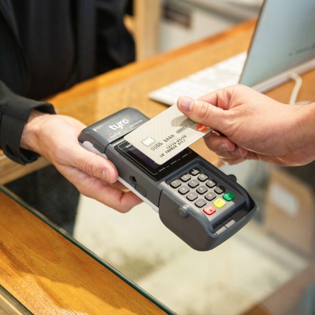Person paying with credit card machine