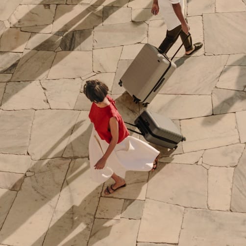 Travelers walking with rolling suitcases