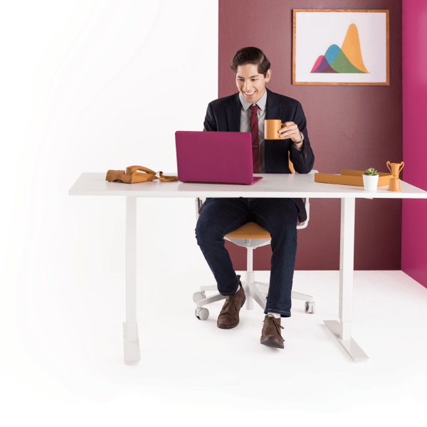 Man sitting at desk with laptop, closing deals with his team while collaborating in Slack.