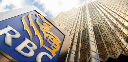 'An RBC sign in front of a skyscraper.'