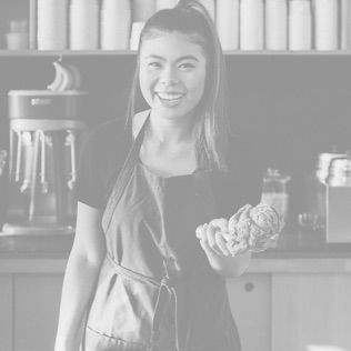 Black and white photo of smiling woman with a scoop of ice cream