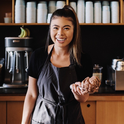 Smiling woman with a scoop of ice cream