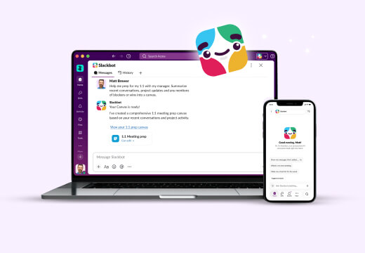 Slackbot sits atop a laptop and phone