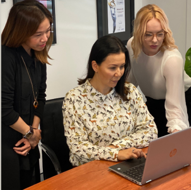 People looking at a laptop screen