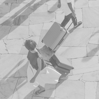 Travelers walking with rolling suitcases