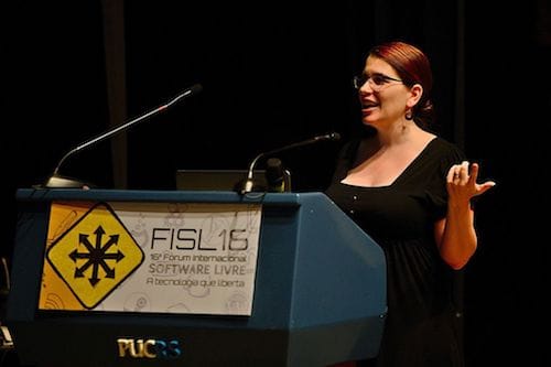 Karen speaks at a podium at International Free Software Forum.